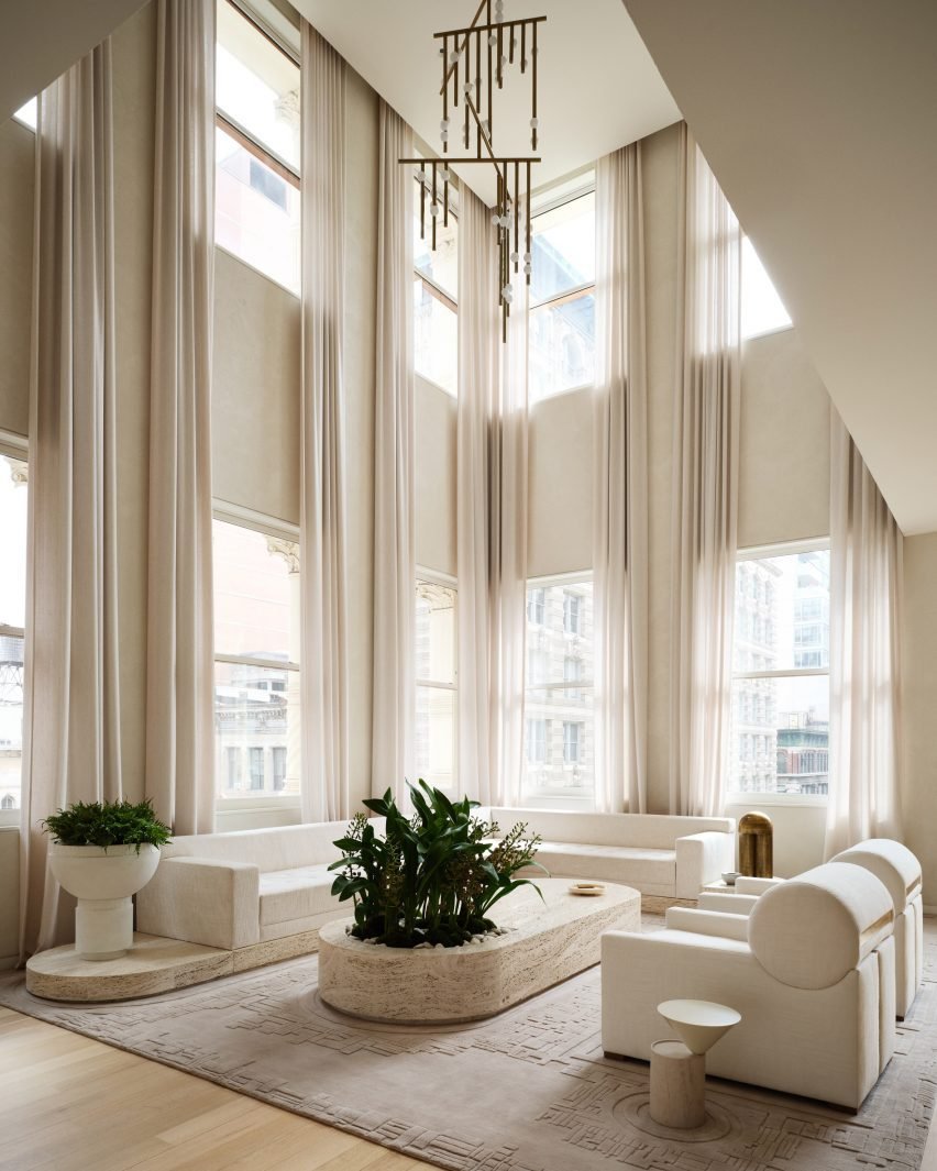 Tribeca loft renovation by Timothy Godbold, featuring a dramatic design with sheer curtains and plants.